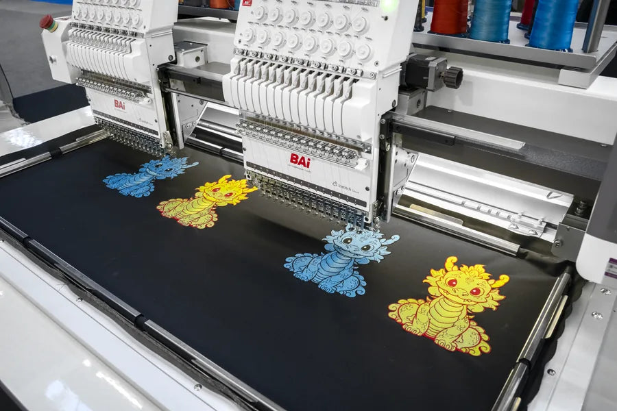 A two-head BAI machine embroidering two garments at once